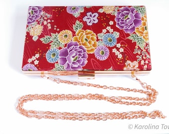 Red clutch bag with rose gold chain