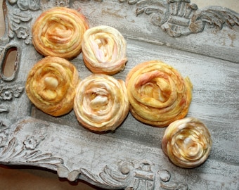 May include: Six decorative, hand-spun, silk yarn balls in shades of yellow and orange on a white, ornate tray.