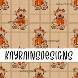 May include: A repeating pattern featuring cartoon teddy bears wearing orange pumpkin costumes. The bears are set against a tan plaid background. The text "KAYRAINSDESIGNS" is displayed in a white rectangular banner across the bottom of the image.