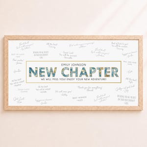 May include: A rectangular wooden frame containing a white sign with the text EMILY JOHNSON NEW CHAPTER WE WILL MISS YOU! ENJOY YOUR NEW ADVENTURE! surrounded by various handwritten messages in gray ink. The letters are filled with blue and gold floral patterns.