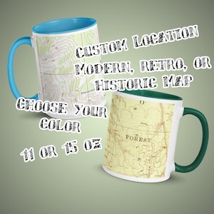May include: Two ceramic coffee mugs with different colored rims. The mug on the left has a light blue rim and a topographic map design. The mug on the right has a green rim and a vintage map design. The text on the mugs reads "CUSTOM LOCATION MODERN, RETRO, OR HISTORIC MAP CHOOSE YOUR COLOR 11 OR 15 OZ".