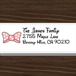 May include: A white return address label with a pink polka dot bow and the text "The Jones Family, 2755 Maple Lane, Beverly Hills, CA 90210".