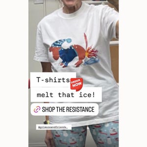 May include: White t-shirt featuring a colorful cartoon illustration of a creature melting ice. The text "melt that ice!" is displayed below the image. The shirt also has the text "SHOP THE RESISTANCE".