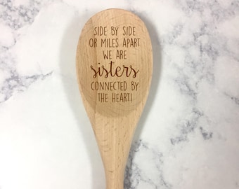 May include: Wooden spoon with the text "Side by side or miles apart we are sisters connected by the heart!" engraved on it.