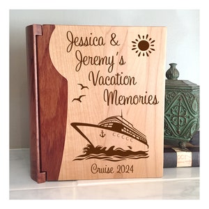 May include: A wooden photo album with a personalized inscription for Jessica & Jeremy's Vacation Memories Cruise 2024. The album features a cruise ship, a sun, and seagulls.