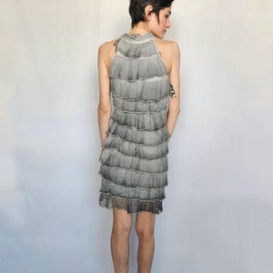 a woman standing in front of a white backdrop