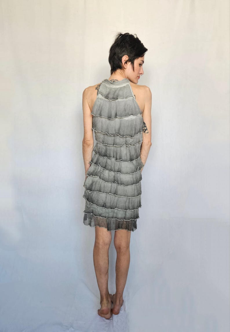 a woman standing in front of a white backdrop