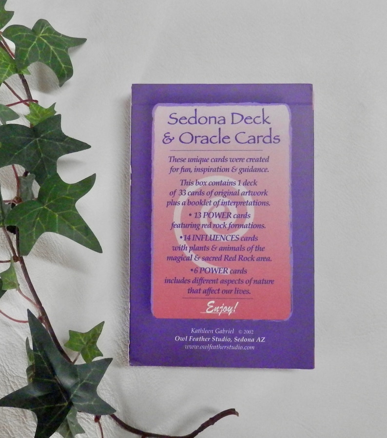 May include: Purple and pink box with the text "Sedona Deck & Oracle Cards". The box contains 33 cards of original artwork, plus a booklet of interpretations. The cards feature red rock formations, plants and animals of the Sedona area, and different aspects of nature.
