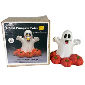 May include: A white ghost figurine with a wide open mouth and raised arms, surrounded by several orange pumpkins with green stems. The item is displayed next to its original cardboard box labeled Halloween Ghost Pumpkin Patch by California Creations.
