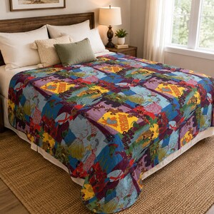 May include: A colorful quilt with a patchwork design featuring various figures and patterns in shades of blue, purple, yellow, and red. The quilt is placed on a bed with white sheets and pillows, creating a cozy and inviting atmosphere.