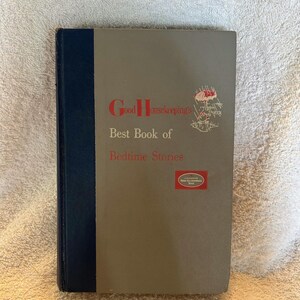 May include: Vintage hardcover book titled "Good Housekeeping's Best Book of Bedtime Stories." The book has a gray cover with red lettering and a small illustration. The spine is dark blue.