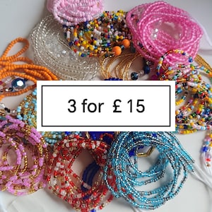 May include: A collection of multi-colored waist beads featuring various patterns, including solid pink, orange, blue, red, and multi-colored strands with clear and metallic accents. A central white rectangular box displays the text 3 for £ 15.