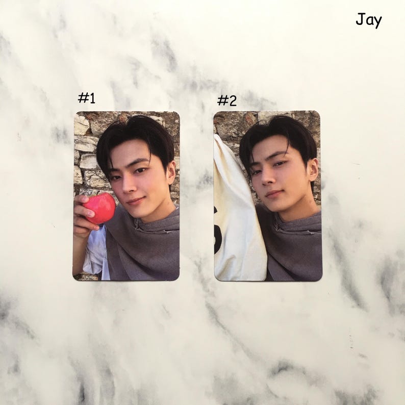 May include: Two rectangular photo cards featuring a person. Card #1 shows the person holding a red apple. Card #2 shows the person with a white bag. The name "Jay" is written in the upper right corner.