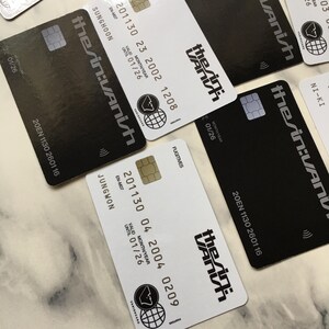 May include: Several black and white credit cards are displayed, featuring the text "the sin:VANish" in a stylized font. Each card includes a chip, a logo, and various numbers and dates, including "VALID MONTH/YEAR UNTIL 01/26".