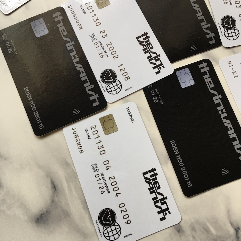 May include: Several black and white credit cards are displayed, featuring the text "the sin:VANish" in a stylized font. Each card includes a chip, a logo, and various numbers and dates, including "VALID MONTH/YEAR UNTIL 01/26".