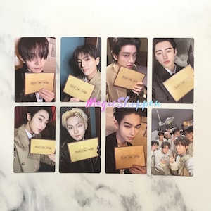 May include: A collection of eight photo cards featuring various individuals holding a brown card with the text "NIGHT TIME SHOW". The cards have a light blue background and are likely promotional items.