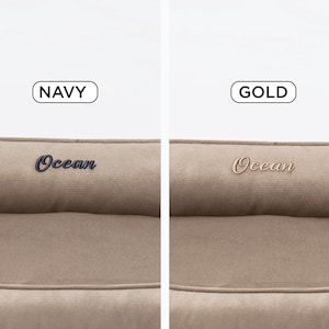May include: Two close-up images of a pet bed. The left image shows a navy blue embroidered "Ocean" logo, with the word "NAVY" above it. The right image shows a gold embroidered "Ocean" logo, with the word "GOLD" above it. The bed is a neutral beige color.