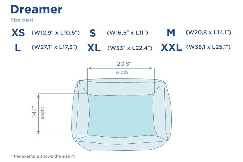 May include: Size chart for a Dreamer dog bed in various sizes, including XS, S, M, L, XL, and XXL. The chart shows the width and length of each size in inches. An illustration of the size M bed is shown.