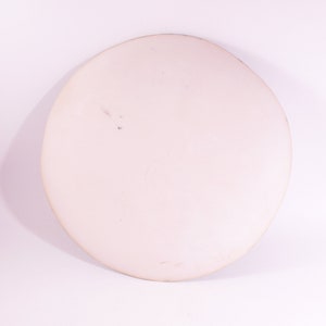 May include: A white ceramic plate with a slightly textured surface.