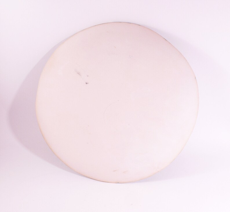 May include: A white ceramic plate with a slightly textured surface.