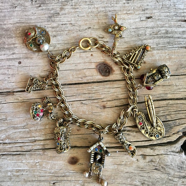 Gold Tone Bracelet / Charm Bracelet / Jewel Tone / Ballerina / Harp / Water Well / Painter's Palette / Bird House / Golf Clubs / Ice Skate