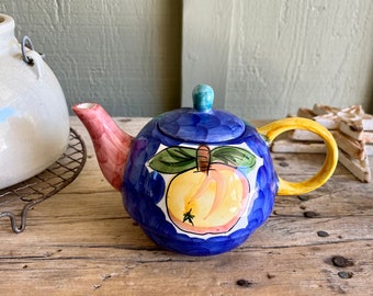 Ceramic Teapot / Small Teapot / Fruit / Pink Cherries / Yellow Apple / Yellow Handle / Pink Spout / Blue Background / Teal Background / Mug