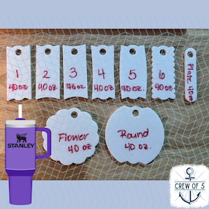 May include: White paper tags with red writing, numbered 1 through 6, and two additional tags labeled "Flower 40 oz" and "Round 40 oz". The tags are on a wooden surface with a blue and white net pattern.