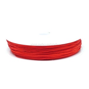Puede incluir: Una bobina de cordón encerado de color rojo brillante, ideal para la elaboración de joyas o manualidades.