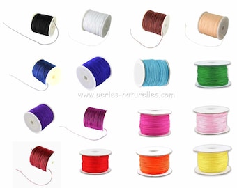 May include: Assortment of spools of waxed cord in various colors, including black, white, brown, beige, blue, green, purple, pink, red, orange, and yellow. The spools are all the same size and shape, and they are arranged in a grid pattern.