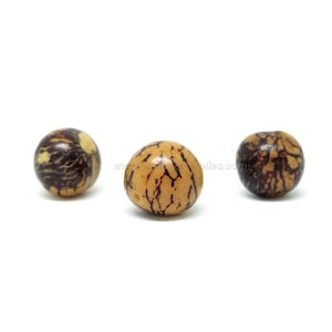 May include: Three round, natural wood beads with a dark brown and light brown marbled pattern.