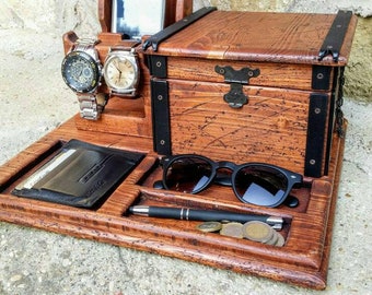 May include: Wooden organizer with compartments for watches, sunglasses, a pen, and a small box. The organizer has a rustic brown finish and black metal accents.