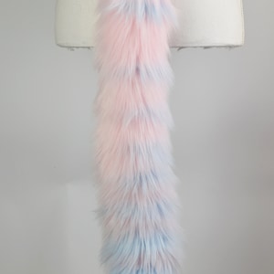 May include: A long, fluffy pink and blue faux fur tail with a light green belt around the waist.