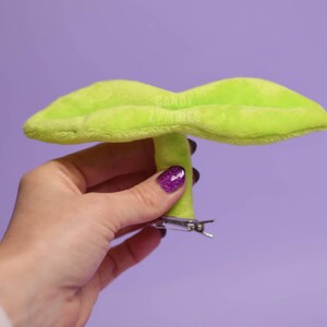 May include: A lime green plush leaf shaped hair clip with a silver metal clip.