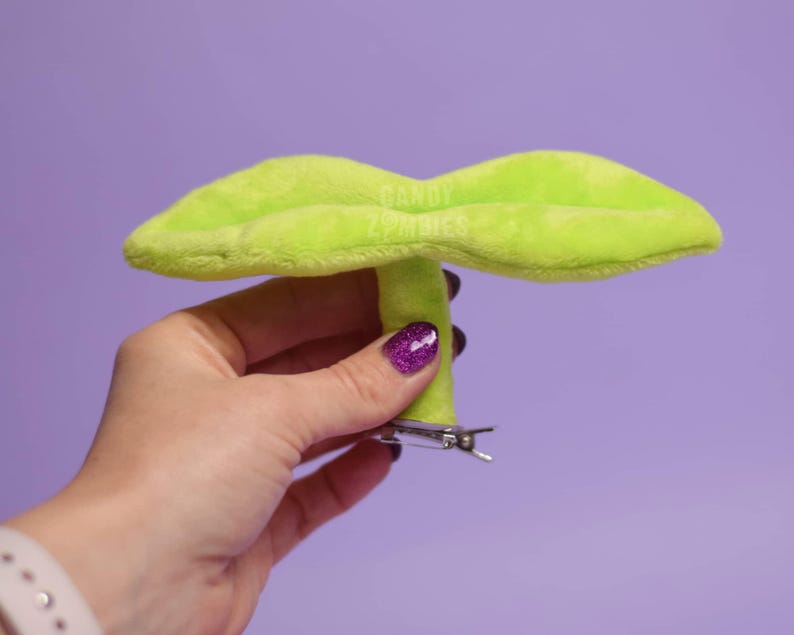 May include: A lime green plush leaf shaped hair clip with a silver metal clip.