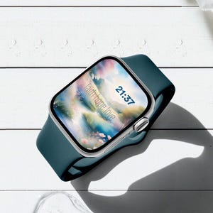 May include: A smartwatch with a dark teal silicone band and a silver metallic casing. The digital display shows the time 21:37 and the text faith hope love in a soft, colorful, abstract floral background with a light, airy aesthetic.