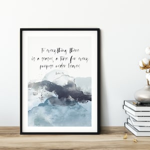 May include: A framed print with a blue and grey watercolour background. The print features the quote "To everything there is a season, a time for every purpose under heaven." with the scripture reference "Ecclesiastes 3:1".