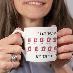 May include: White ceramic mug with a red and white illustration of boots and the text "THE GORGEOUS MOM" and "LOVE FROM YOUR LITTLE" with the names Sehar, Lima, Isla, Zahara, NJ, Eleanor, Zuzu, Alex F, Matylda, and Charlie.