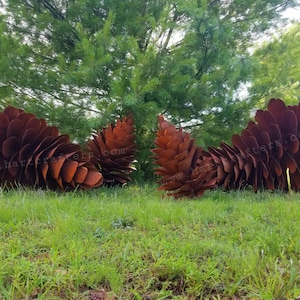 May include: Four large, rust-colored metal sculptures shaped like pinecones, featuring layered, overlapping petal-like segments. The sculptures are arranged in a row, displaying a weathered, oxidized finish with the text www.hartcrafters.com visible.