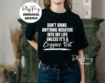 May include: Black t-shirt with the text "DON'T BRING ANYTHING NEGATIVE INTO MY LIFE UNLESS IT'S A Coggins Test" in white. The shirt also features the "Ritzy Pony" logo and "ORIGINAL DESIGN" text.