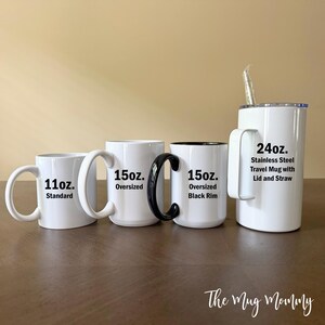 May include: A collection of four white drink containers: an 11oz. standard mug, a 15oz. oversized mug, a 15oz. oversized mug with a black rim and handle, and a 24oz. stainless steel travel mug with a lid and straw, all featuring black text.