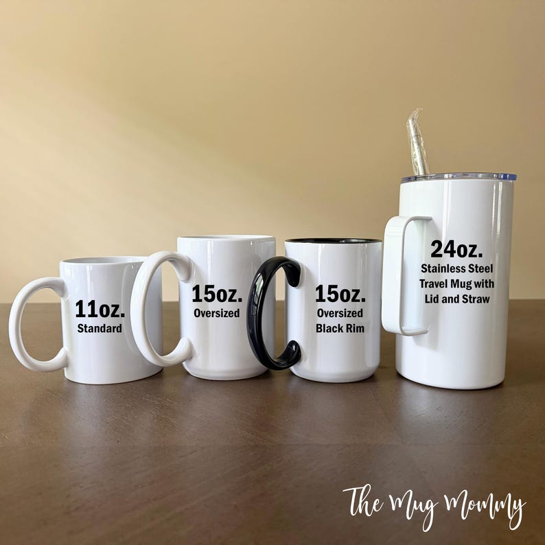 May include: A collection of four white drink containers: an 11oz. standard mug, a 15oz. oversized mug, a 15oz. oversized mug with a black rim and handle, and a 24oz. stainless steel travel mug with a lid and straw, all featuring black text.