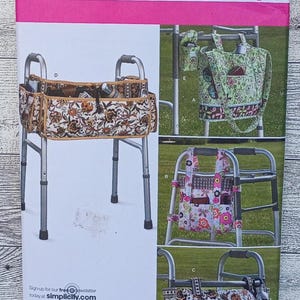 May include: A Simplicity 2300 sewing pattern envelope for walker bags. The front displays four variations of fabric pouches designed to attach to a metal walker, featuring floral and geometric patterns in various colors with multiple pockets.