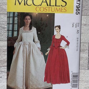 May include: McCall's Costumes sewing pattern for a historical dress. The pattern is for sizes 6-8-10-12-14. The pattern includes two different styles of dresses, one in red and one in white.