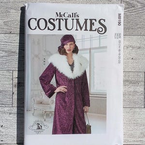 May include: McCall's Costumes sewing pattern for a purple and white long coat with a fur collar. The pattern is for sizes 14-16-18-20-22. The pattern number is M8190.
