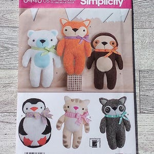 May include: A sewing pattern for making six plush toys: a bear, fox, sloth, penguin, cat, and raccoon. The pattern is from Simplicity and is for one size. The pattern is designed and printed in the USA.