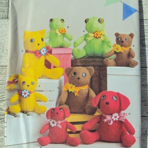 May include: A sewing pattern for making eight stuffed animals: a cat, two frogs, a bear, and three dogs. The pattern is from Simplicity and is size one. The pattern includes instructions for making the animals and the text "8442 os" is printed on the front of the pattern.