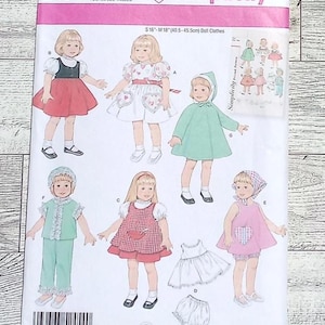 May include: Simplicity sewing pattern 2454 for doll clothes, size A, all sizes. The package features illustrations of various doll outfits, including dresses, pants, and a hooded cape. The text on the package includes "S16-M18 (40.5-45.5cm) Doll Clothes."