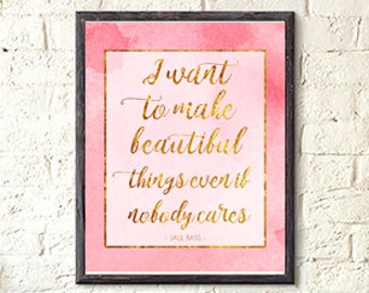 May include: A framed pink and gold watercolor print with the quote "I want to make beautiful things even if nobody cares -  Sally Bass".