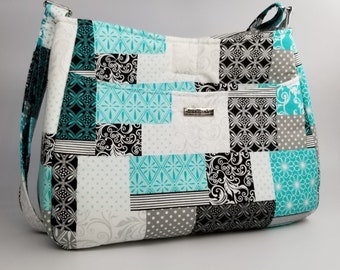 Beautiful Teal/Black Patchwork pattern handbag, made with 100% cotton material, 1/4 inch foam interfacing, Lightweight. adjustable handles,