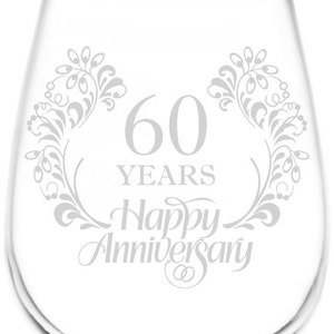 May include: A clear glass wine glass with a design etched into the side. The design features a floral motif and the text "60 Years Happy Anniversary".
